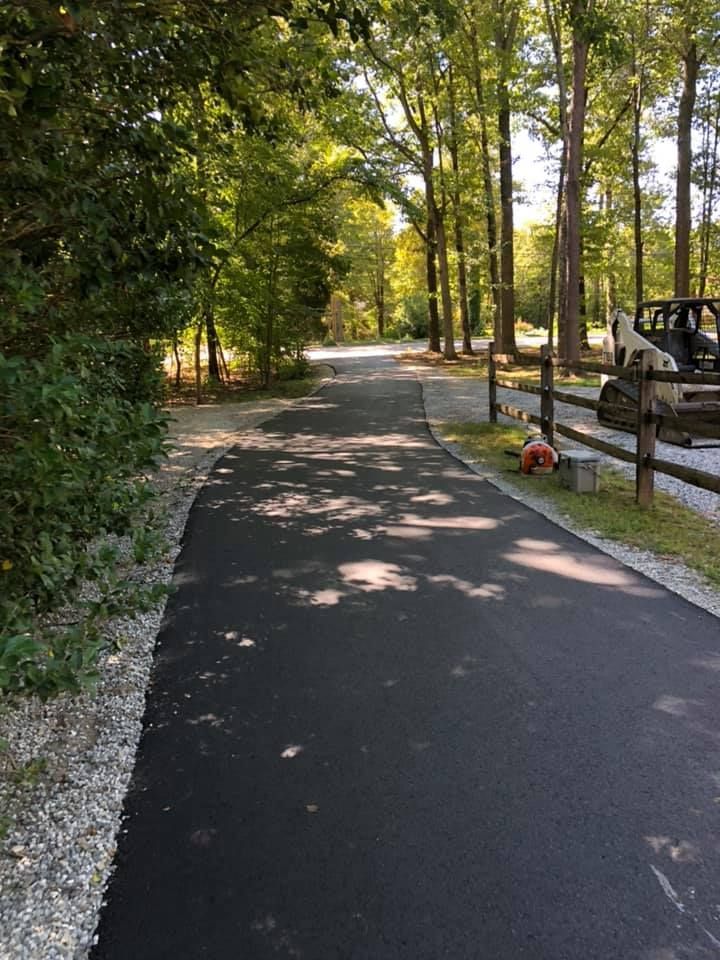 a car is parked on the side of a road next to a fence