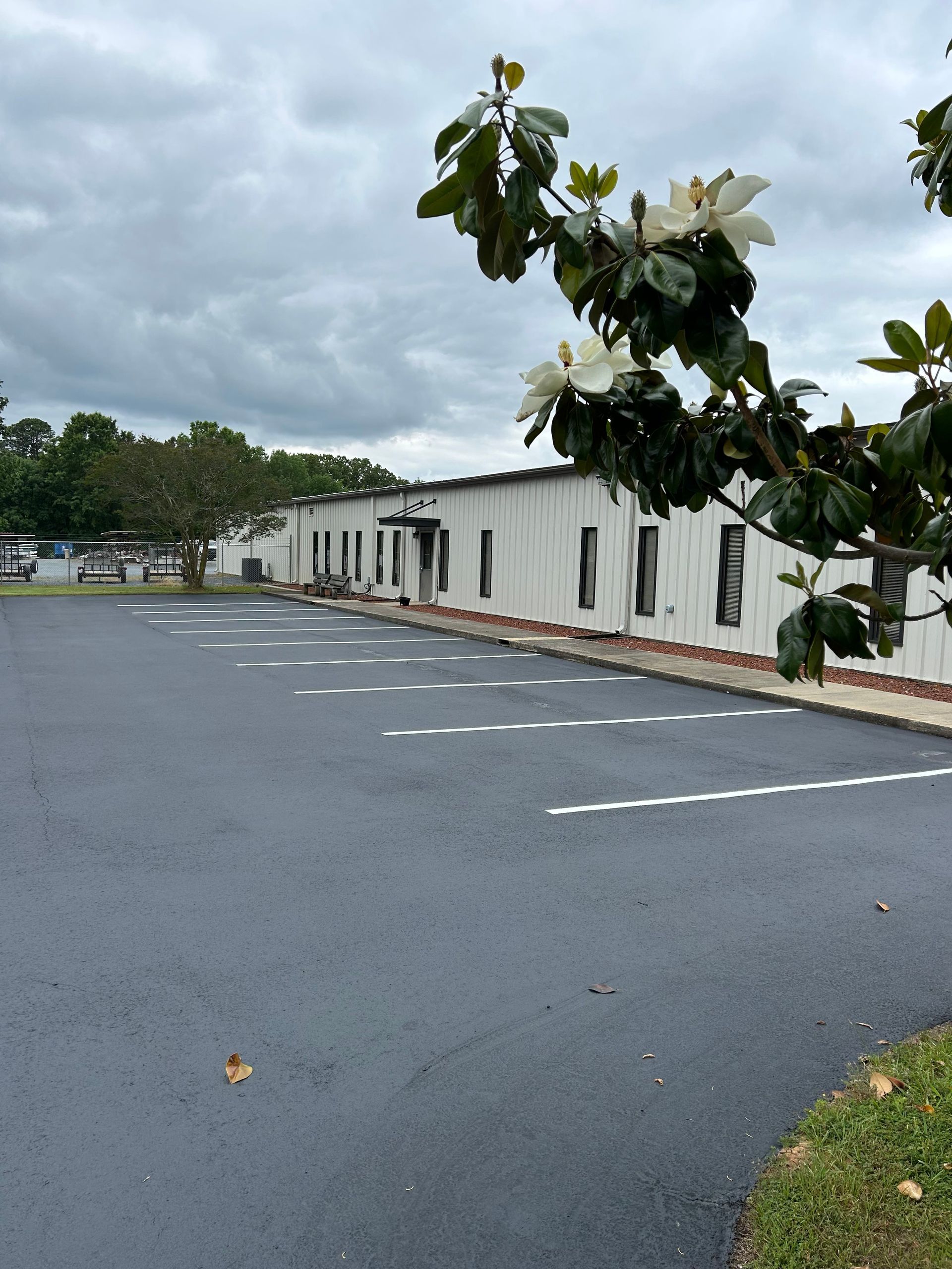 a parking lot with a white building in the background