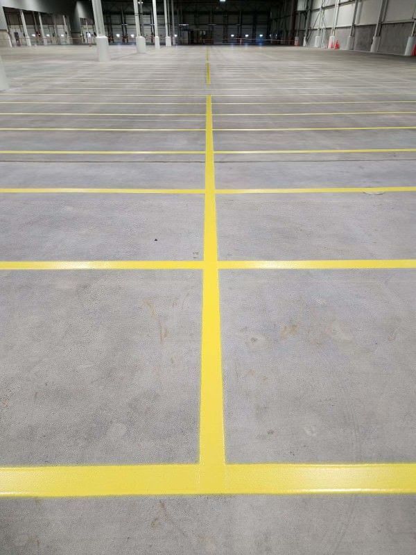 large empty warehouse with yellow lines on the floor