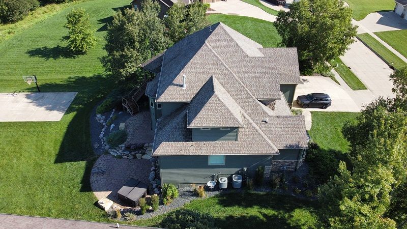 An aerial view of a large house in a residential area.