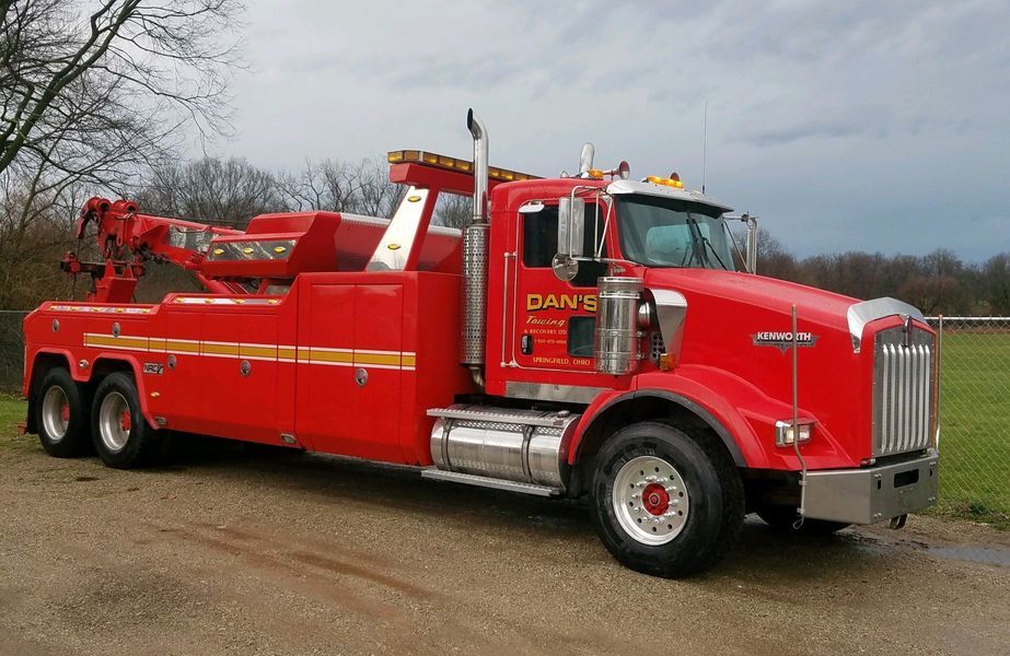 Red tow truck parked outdoors.