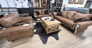Living room with two brown sofas and a wooden coffee table on a light floor