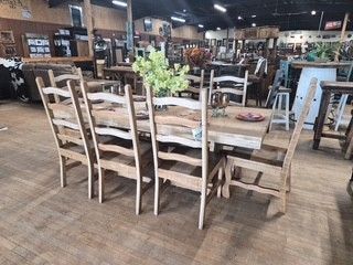 Rustic dining table and chairs in a large indoor furniture showroom