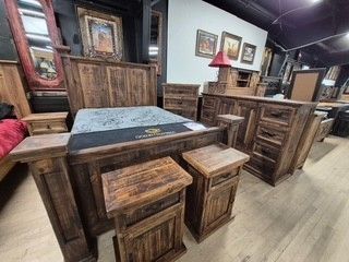 Rustic furniture showroom with wooden tables, stools, and benches around a blue-topped table
