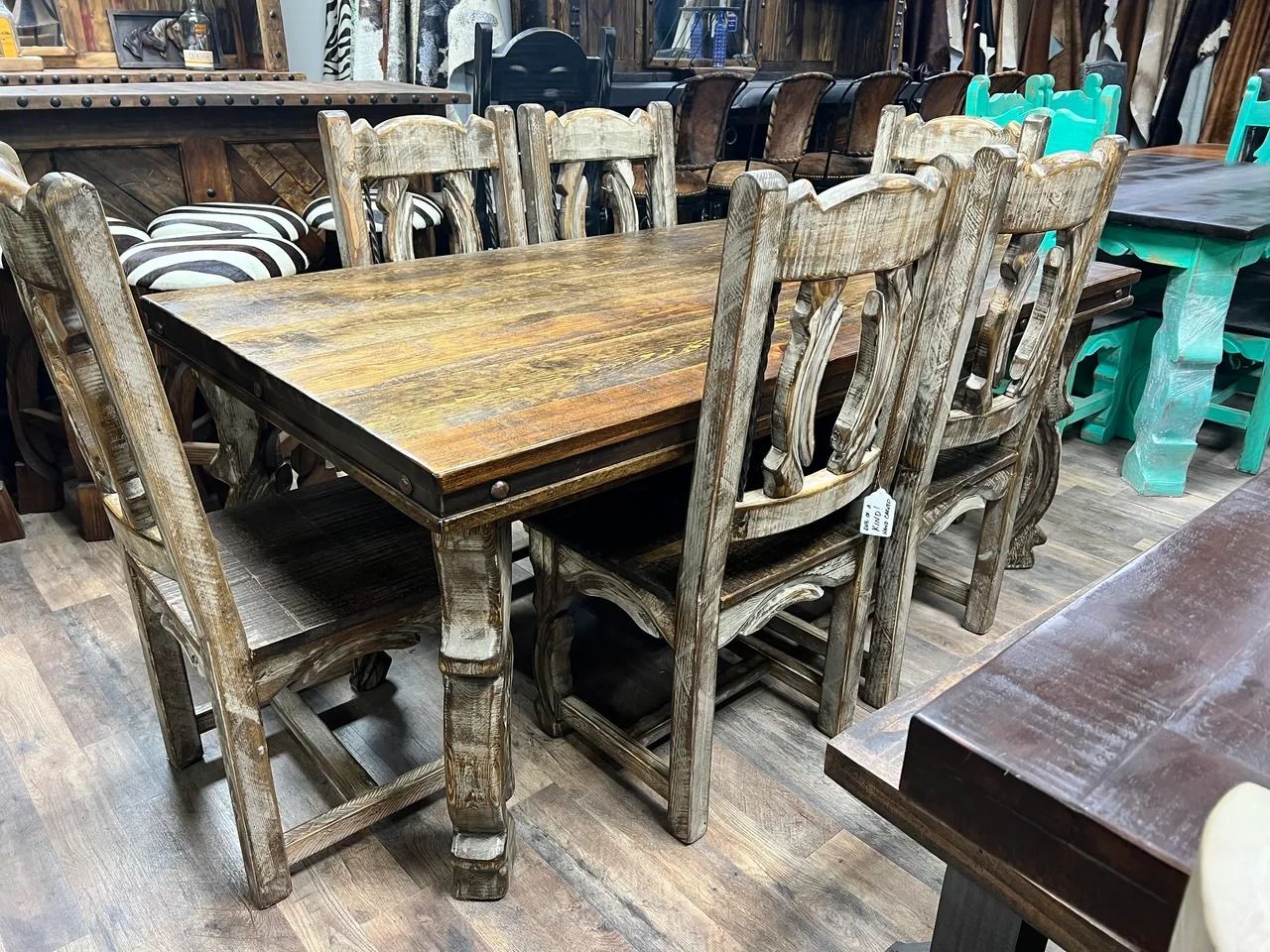 Wooden dining table and chairs, rustic style, indoor setting.