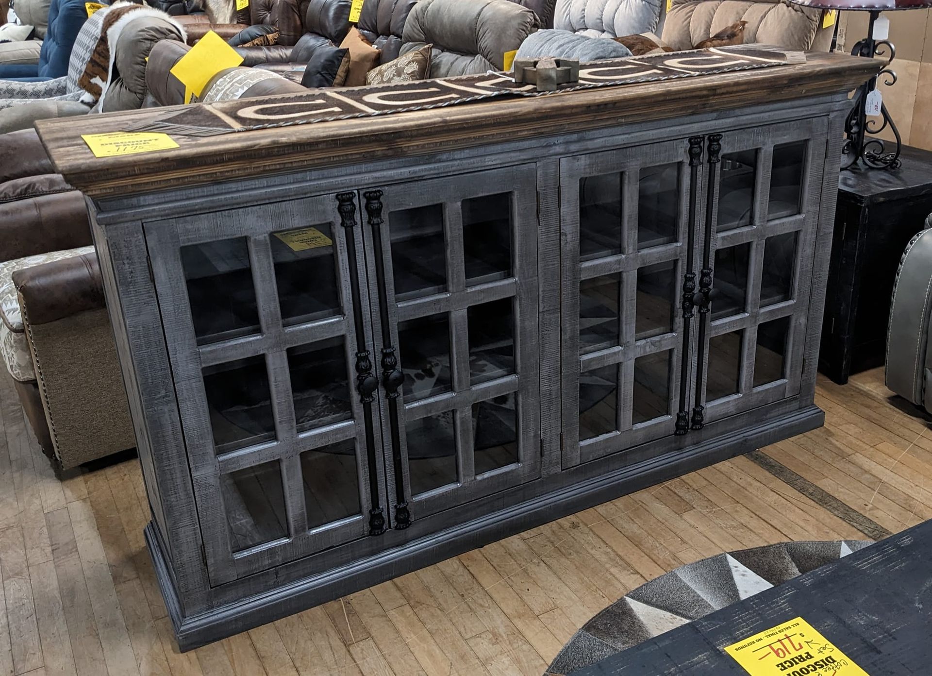 Gray and brown wooden cabinet with glass doors and metal hardware.