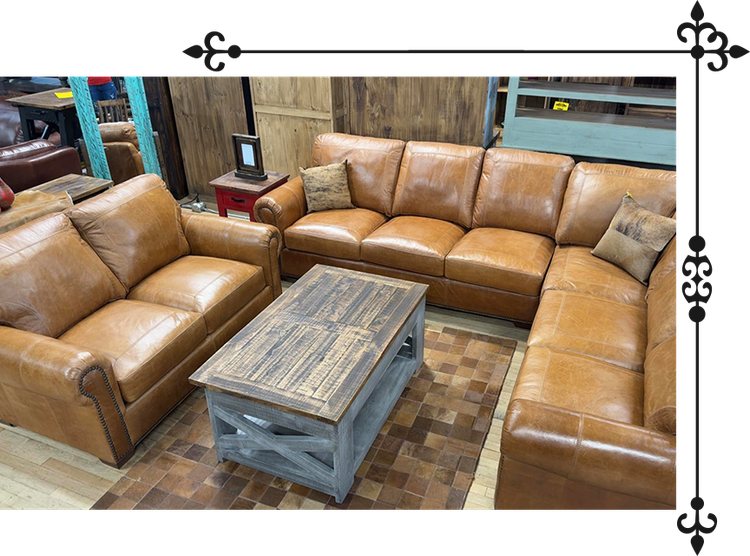 Brown leather sectional sofa and matching armchair, coffee table, in a furniture store.