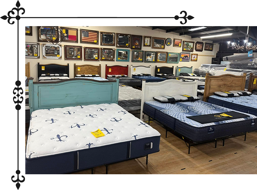 Mattresses on display in a showroom with colorful headboards and framed art on the wall.
