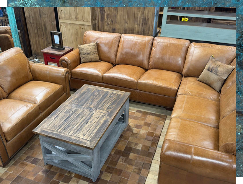 Leather sectional sofa with matching armchair and weathered wooden coffee table.