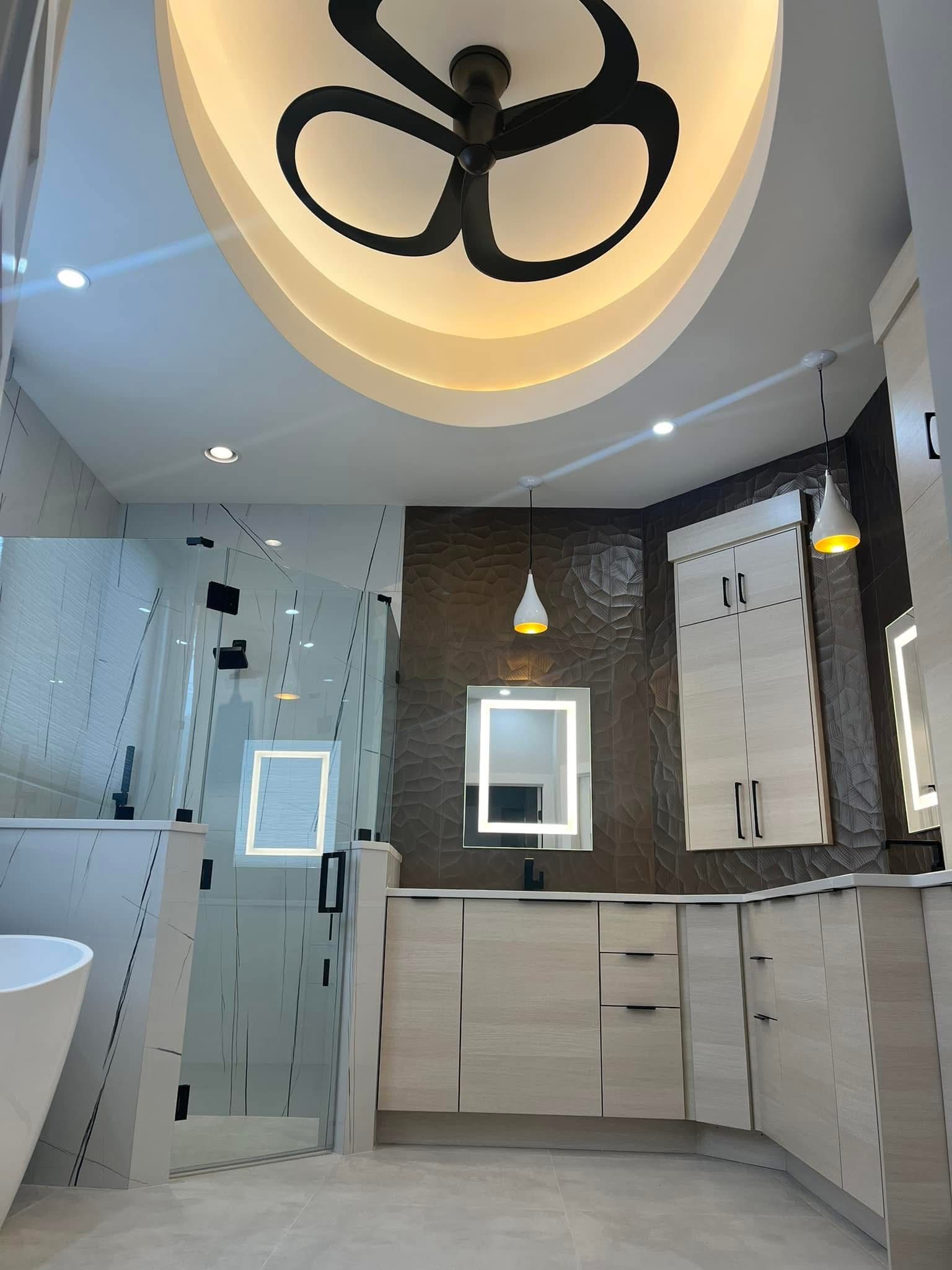 Modern bathroom with glass shower, light wood cabinetry, and a textured brown tile wall.