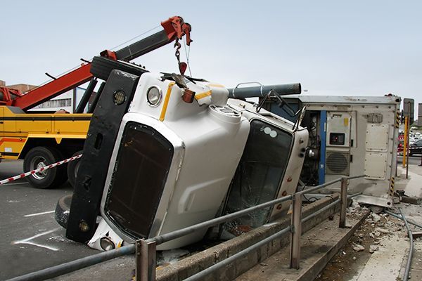 A white truck is being towed by a tow truck.