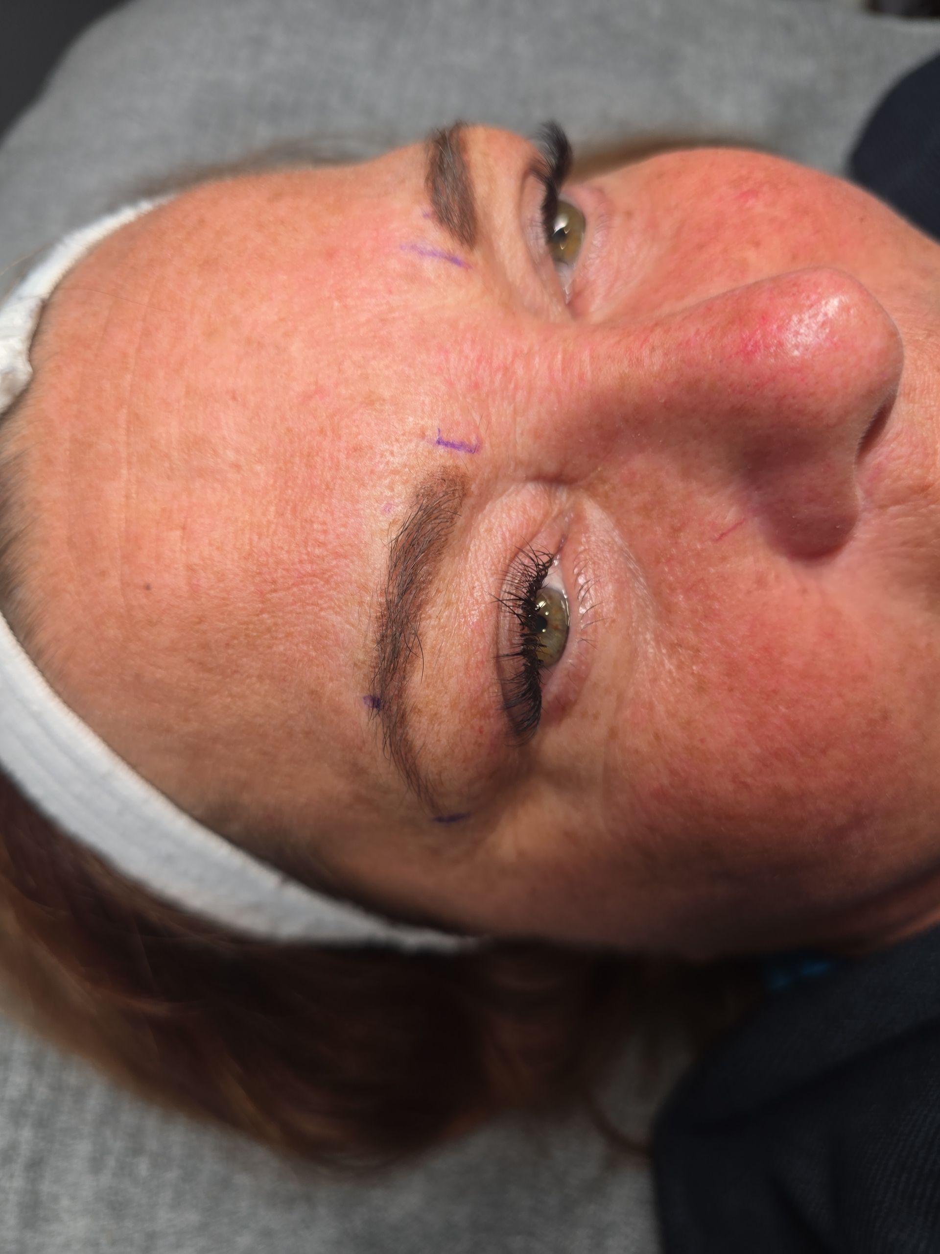 A close up of a woman 's face with a headband on.