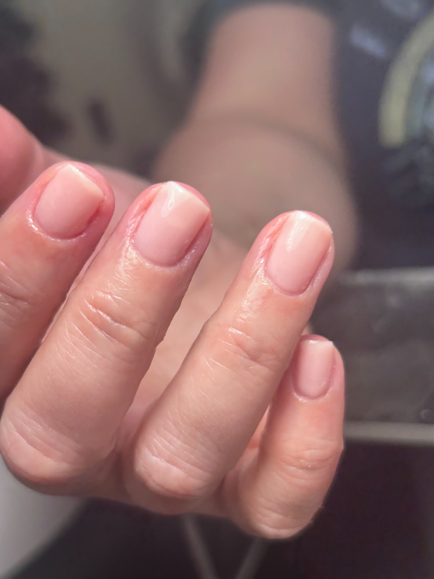 A close up of a person 's hands with long nails.