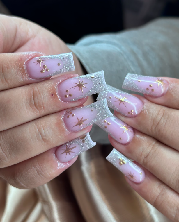 A close up of a person 's nails with a star design.