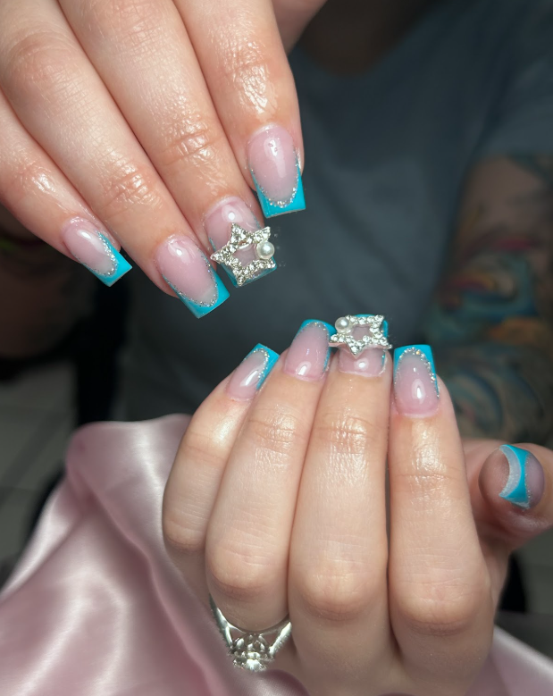 A woman is holding a pair of earrings in her hands.