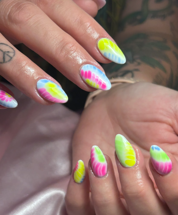 A close up of a woman 's nails with a peace sign tattoo.