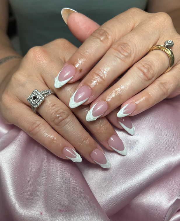A close up of a woman 's hands with rings on them.