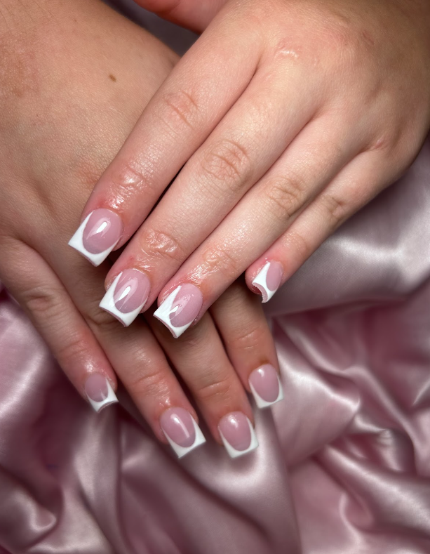 A close up of a person 's nails on a pink cloth.