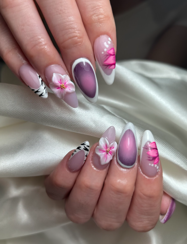 A close up of a woman 's nails with flowers on them.