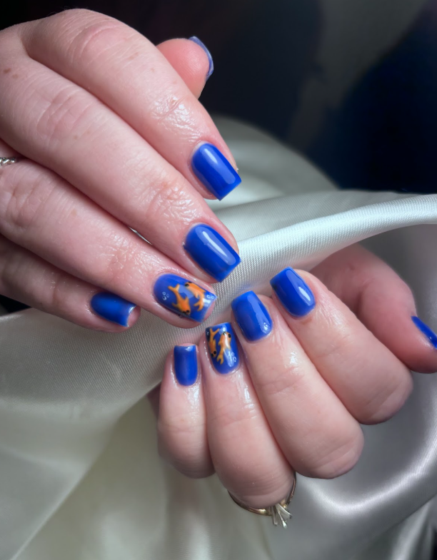 A close up of a person 's nails with blue nail polish.