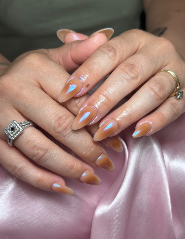 A close up of a woman 's hands with rings on them.