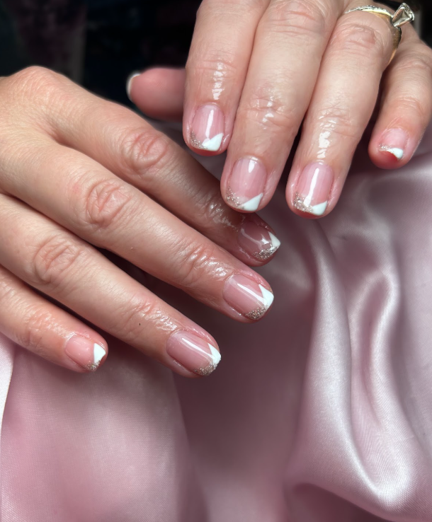 A close up of a woman 's nails on a pink cloth.