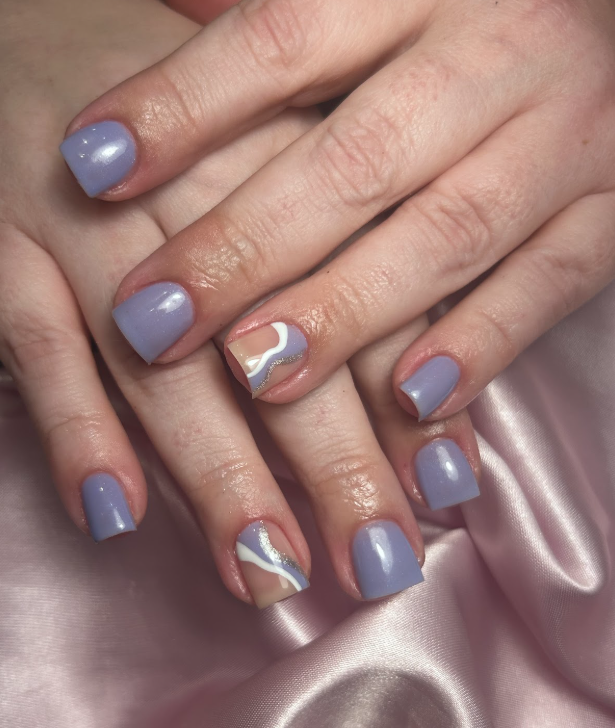 A close up of a woman 's nails on a pink cloth.