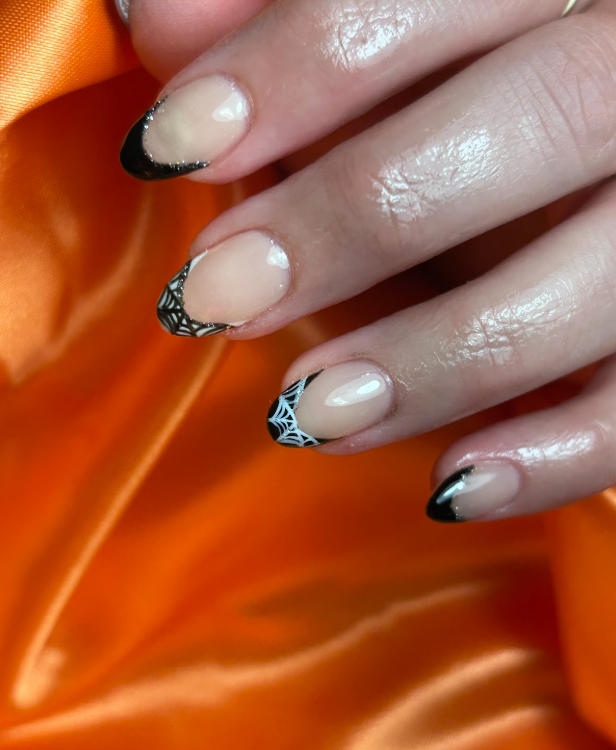 A close up of a woman 's nails on an orange cloth.