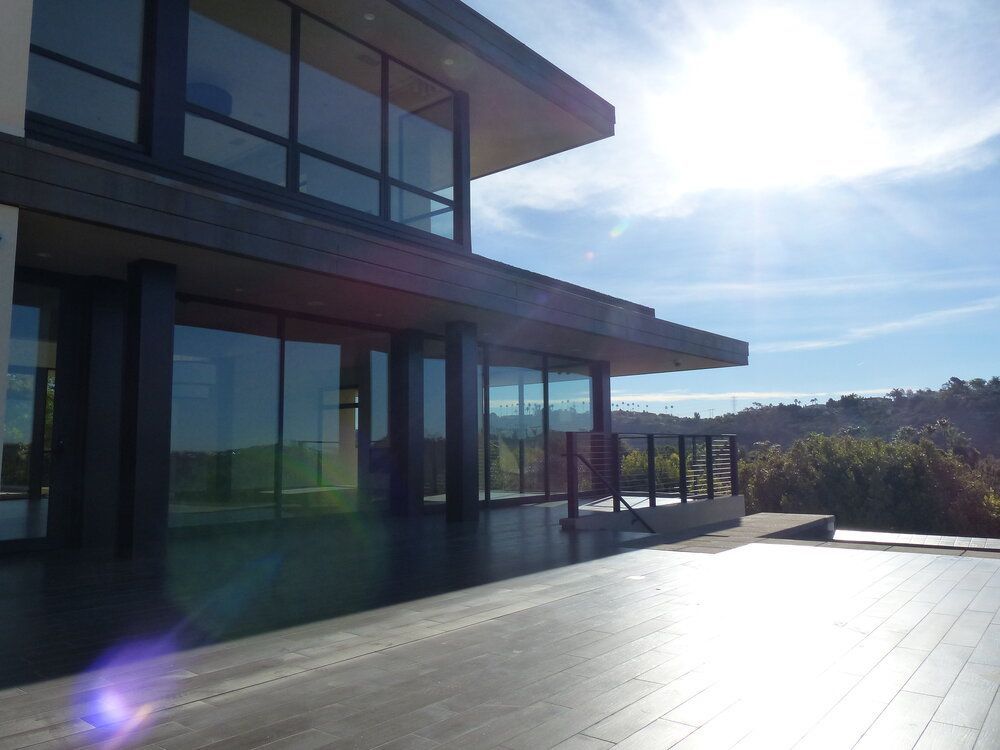 A large house with lots of windows and a wooden deck