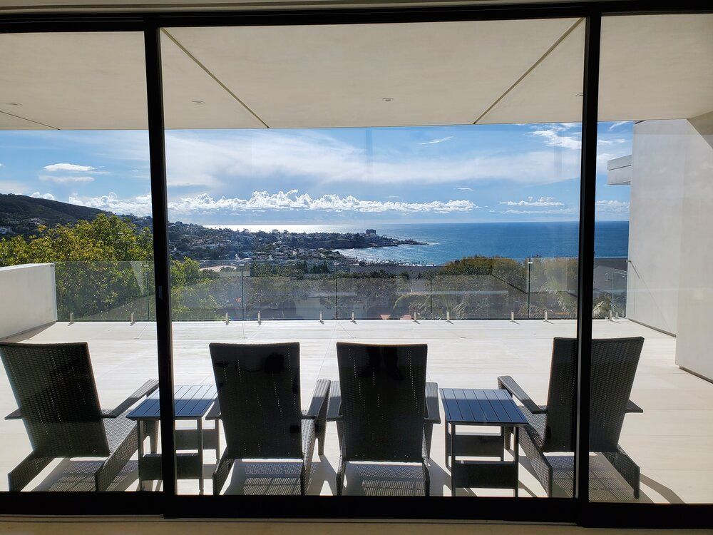 A view of the ocean through a sliding glass door