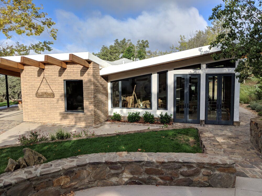 A large house with a lot of windows and a stone walkway