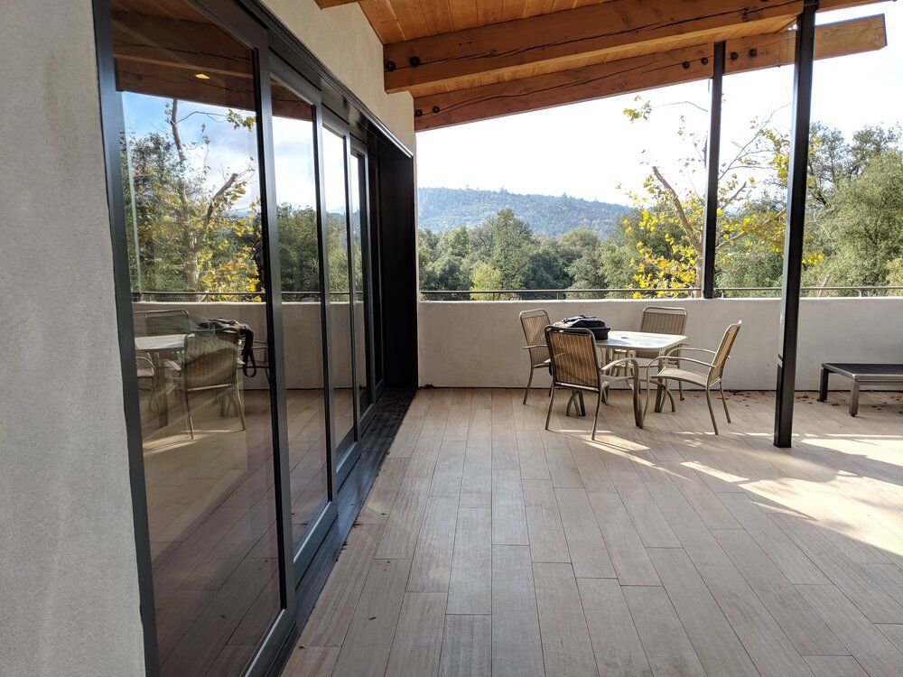 A large patio with a table and chairs on it