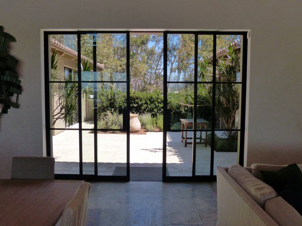 A living room with sliding glass doors leading to a patio