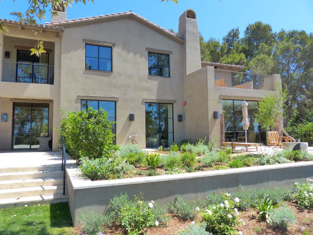 A large house with a lot of windows and a chimney