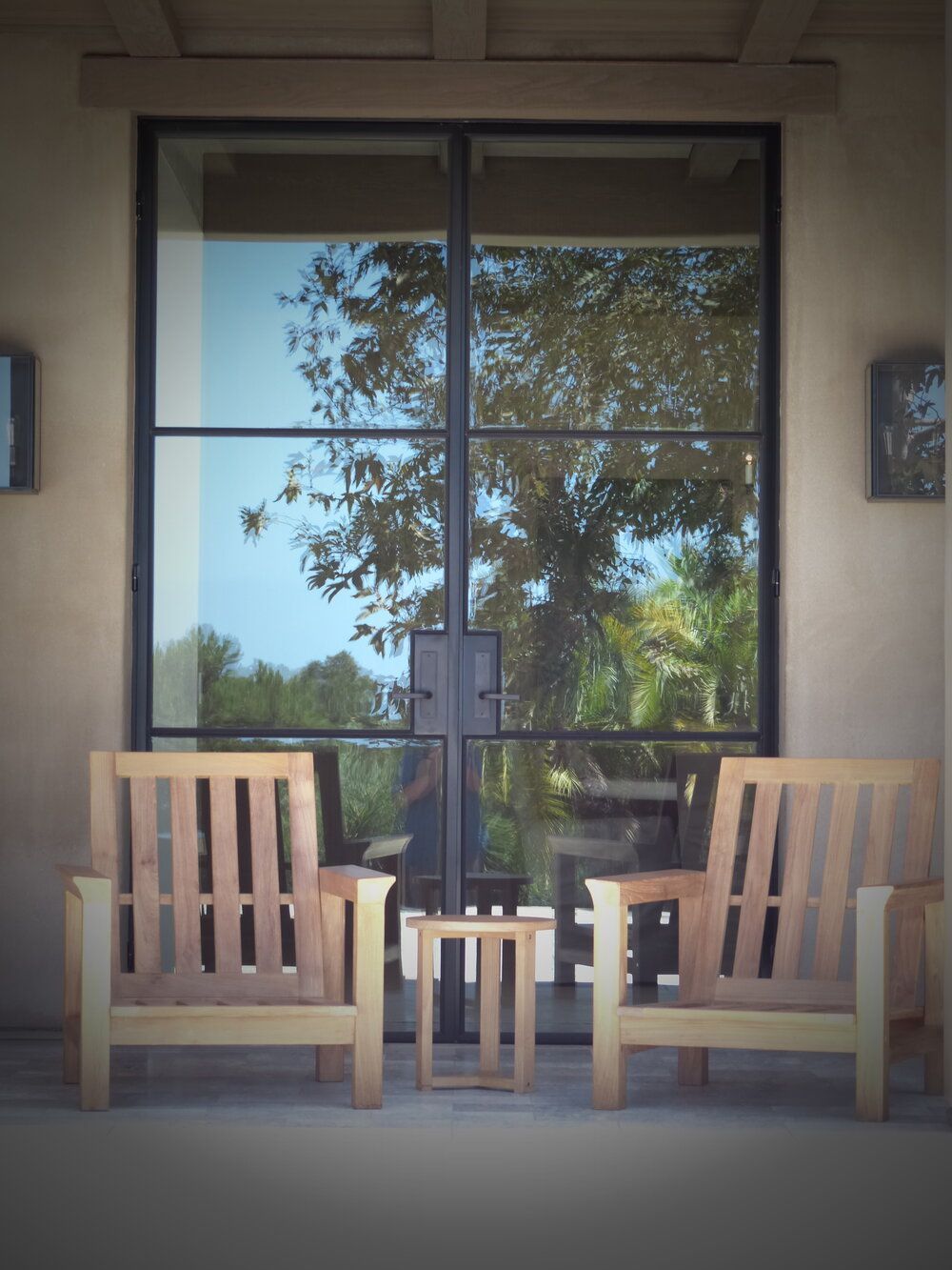 Two chairs and a table in front of a glass door