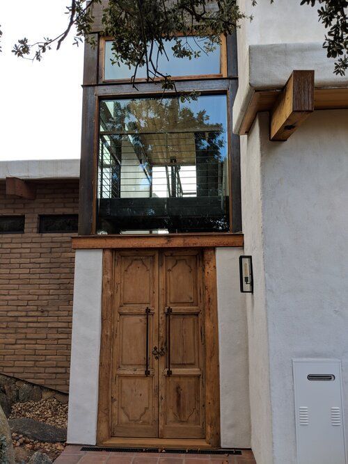 A house with a wooden door and a large window