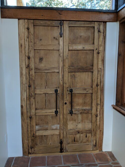 A wooden door with a window behind it