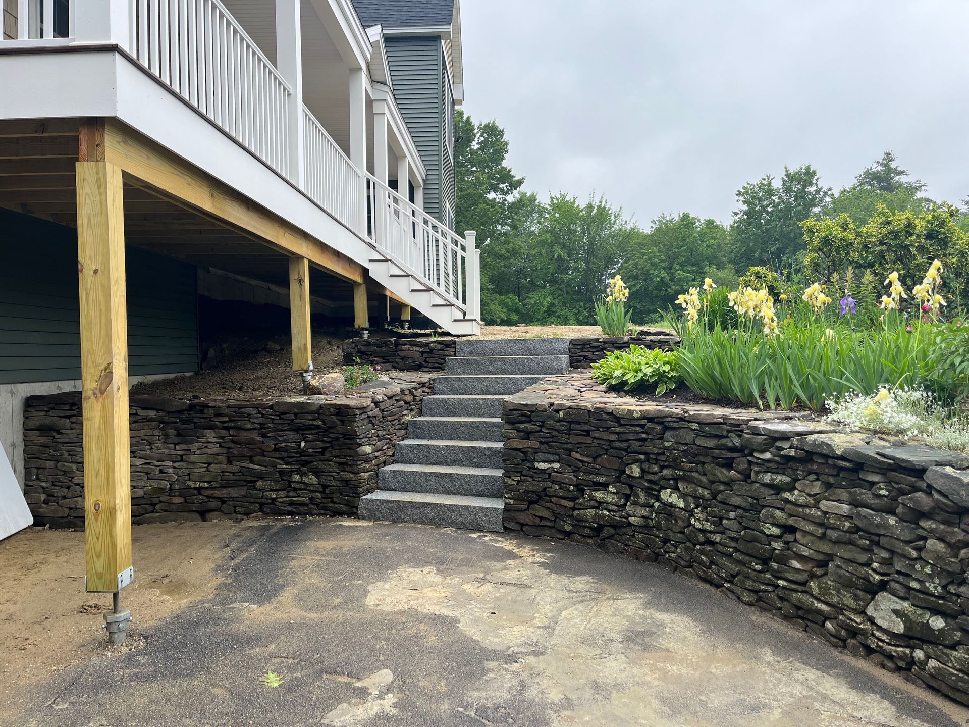 a house with a deck and stairs leading up to it