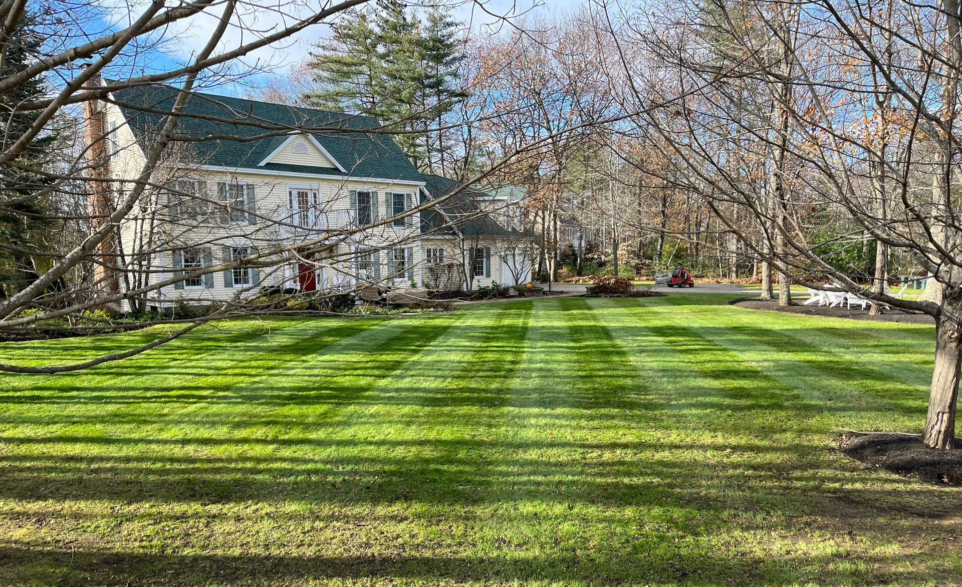 a large house with a lush green lawn in front of it