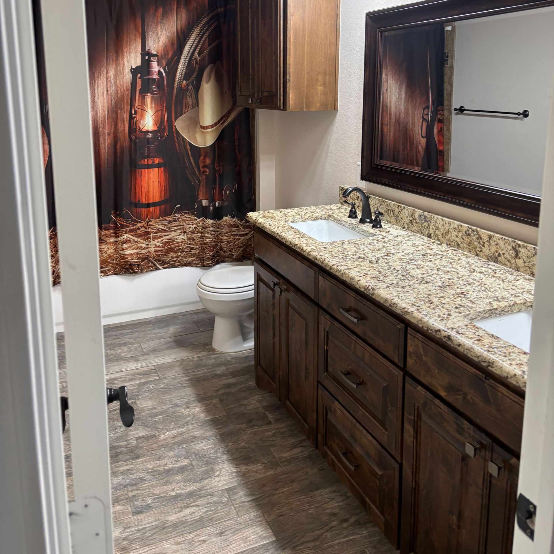 A bathroom with two sinks and a toilet