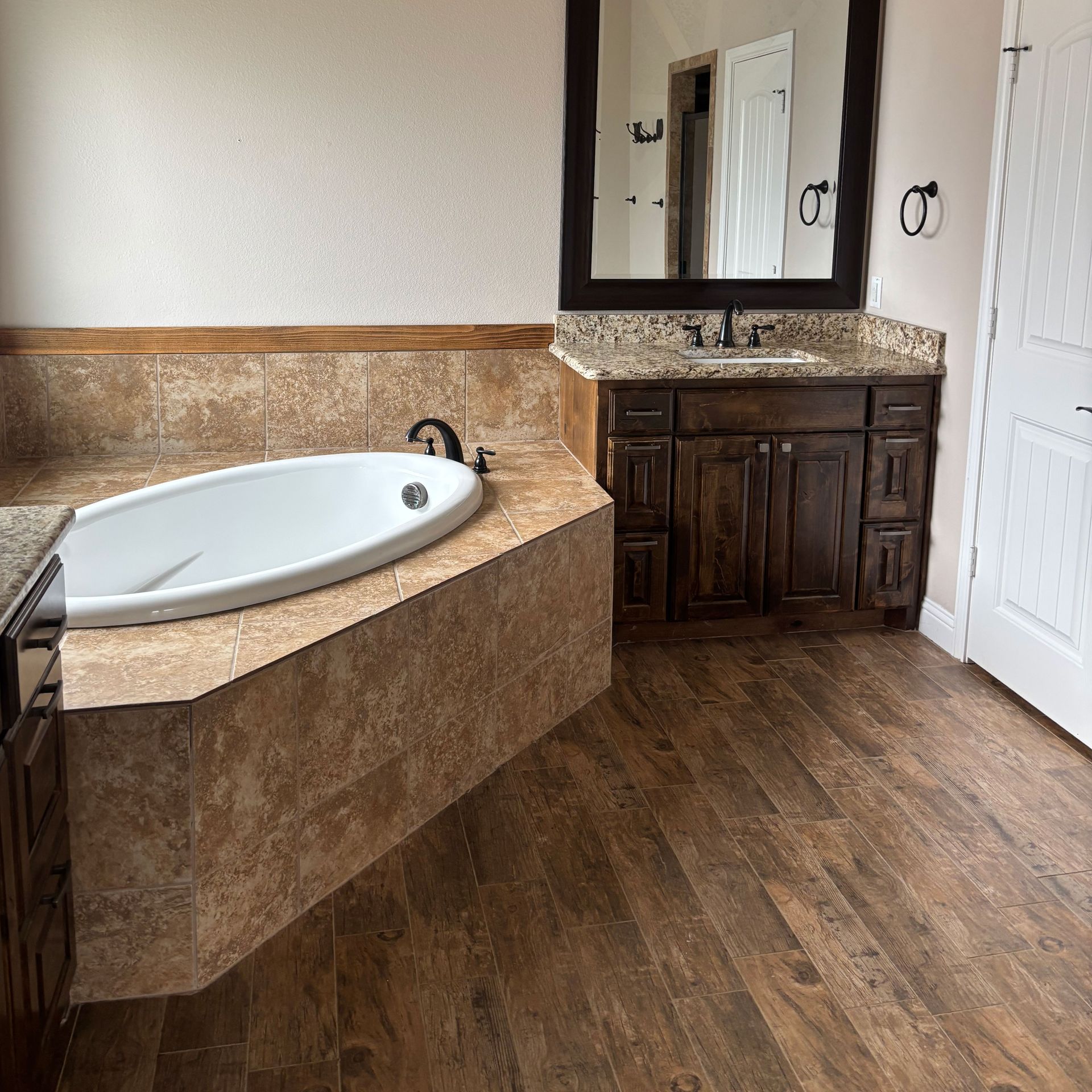 A bathroom with a jacuzzi tub and a sink