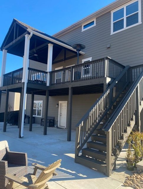 A house with a large deck and stairs leading up to it