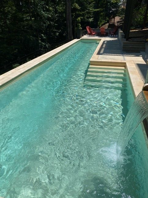 There is a waterfall in the middle of the pool.
