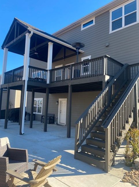 A house with a large deck and stairs leading up to it