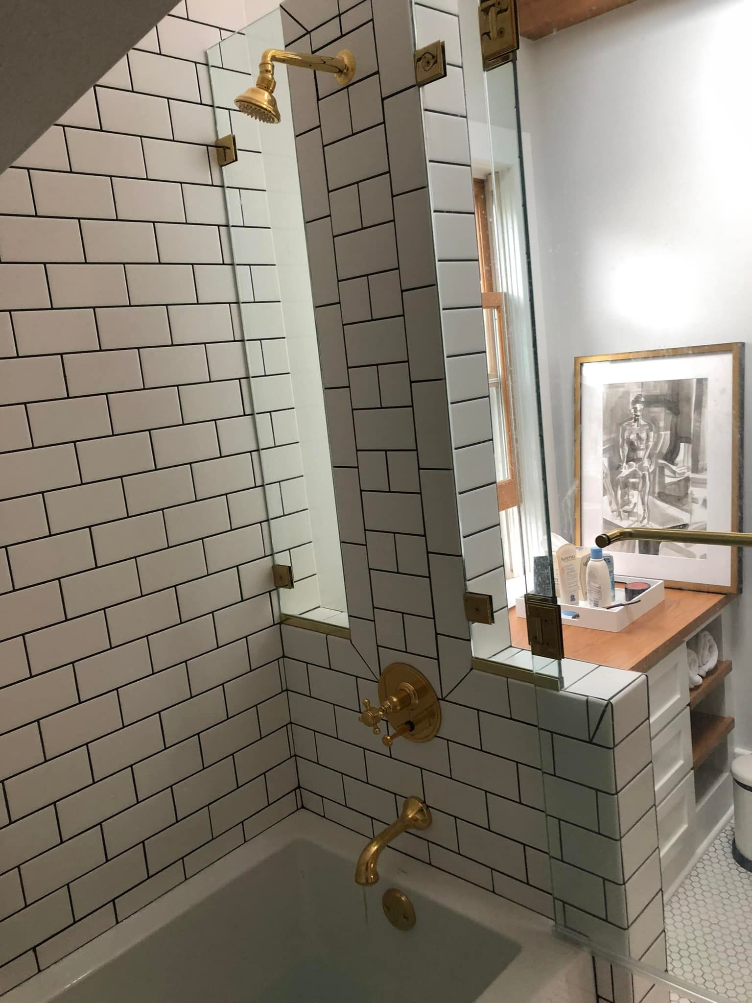 A bathroom with white brick walls and a bathtub