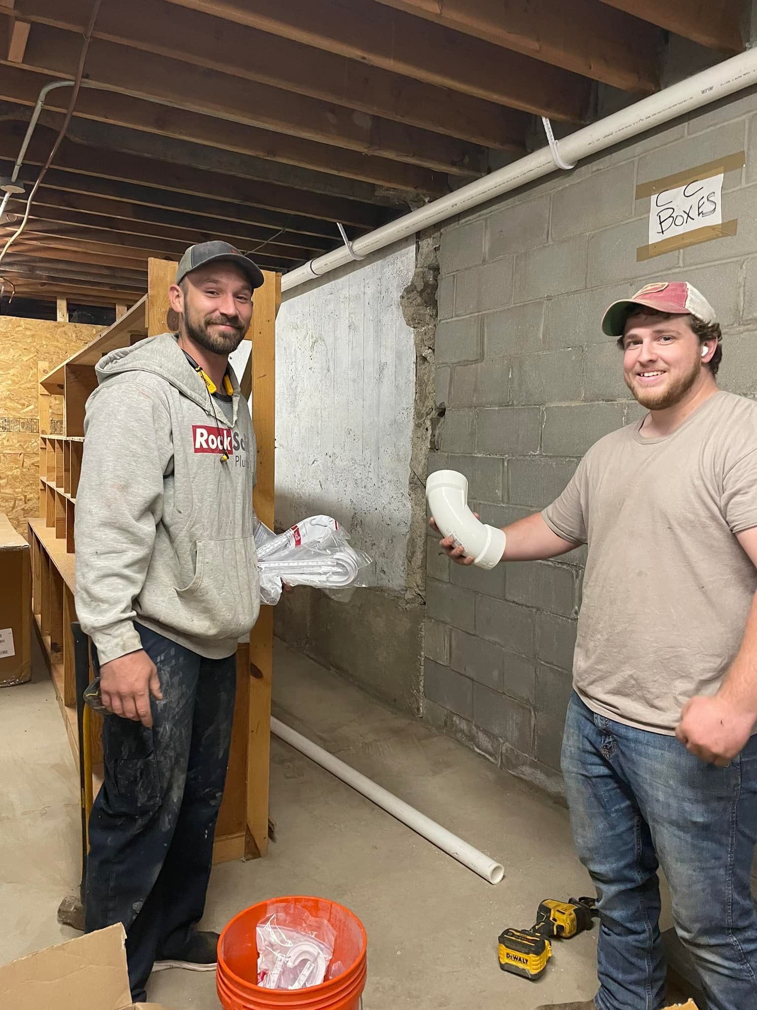 Two men are standing next to each other in a room.