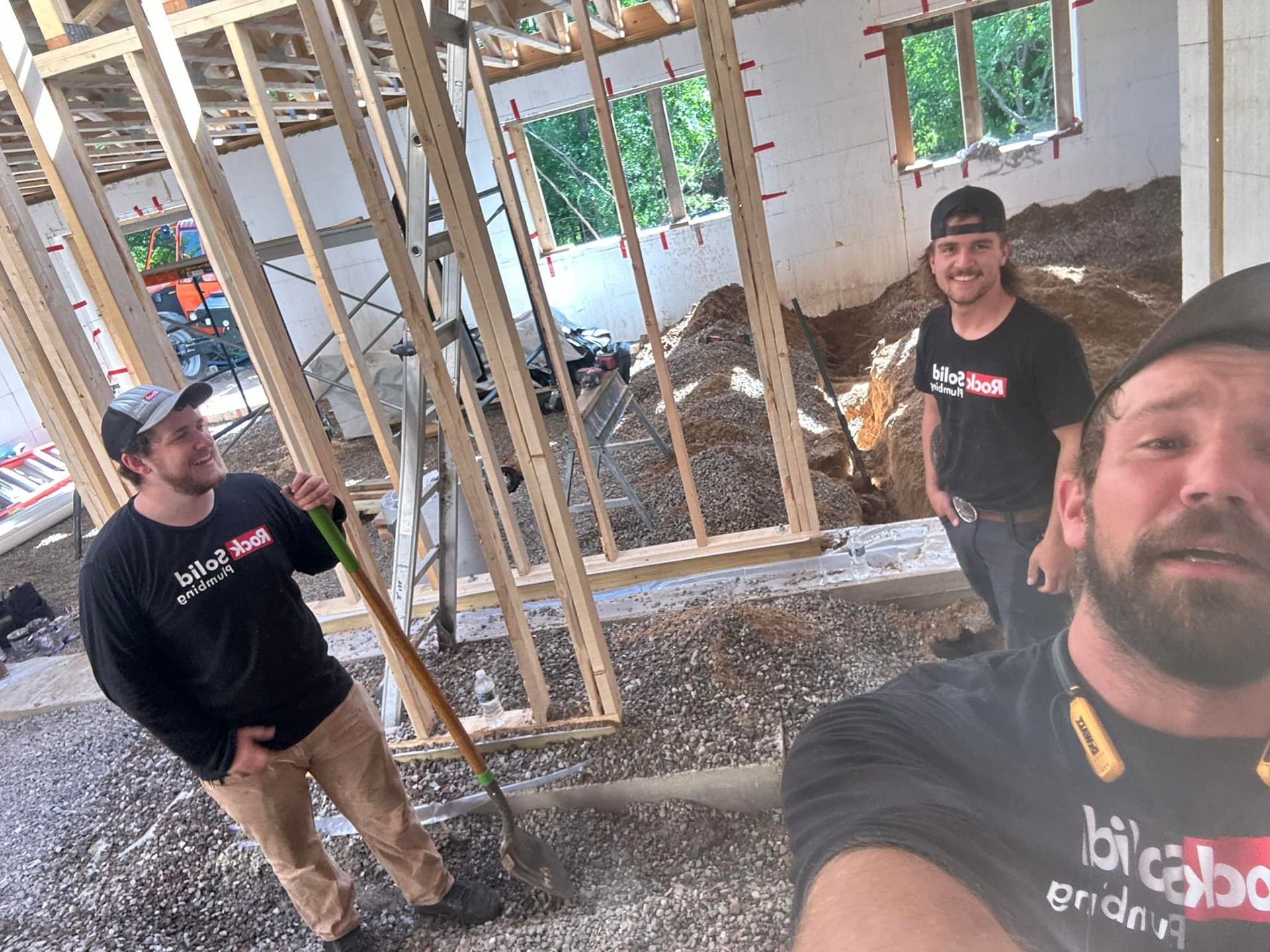 A group of men are standing in a building under construction.