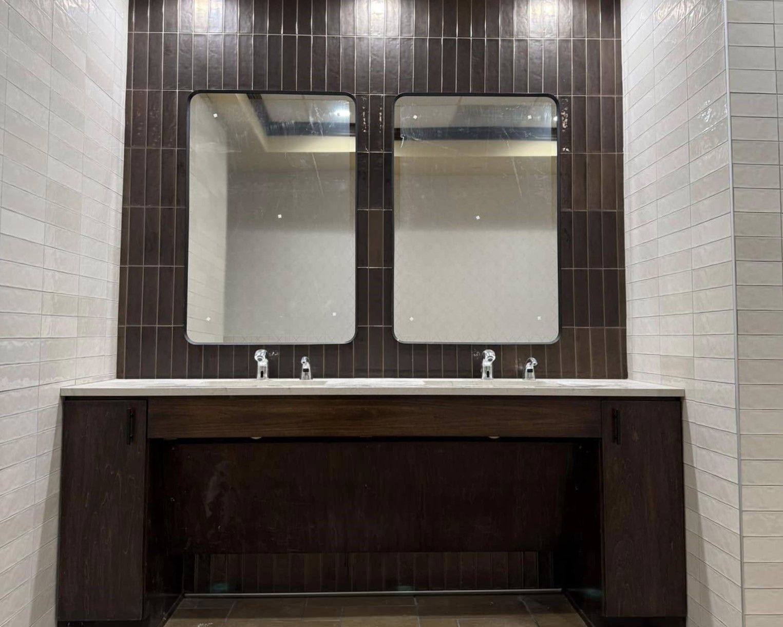 A bathroom with two sinks and two mirrors
