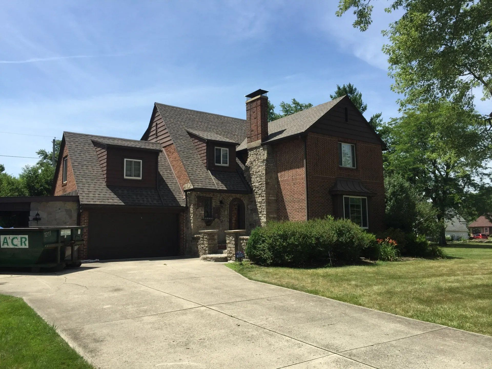 Huge brick house with asphalt roofing
