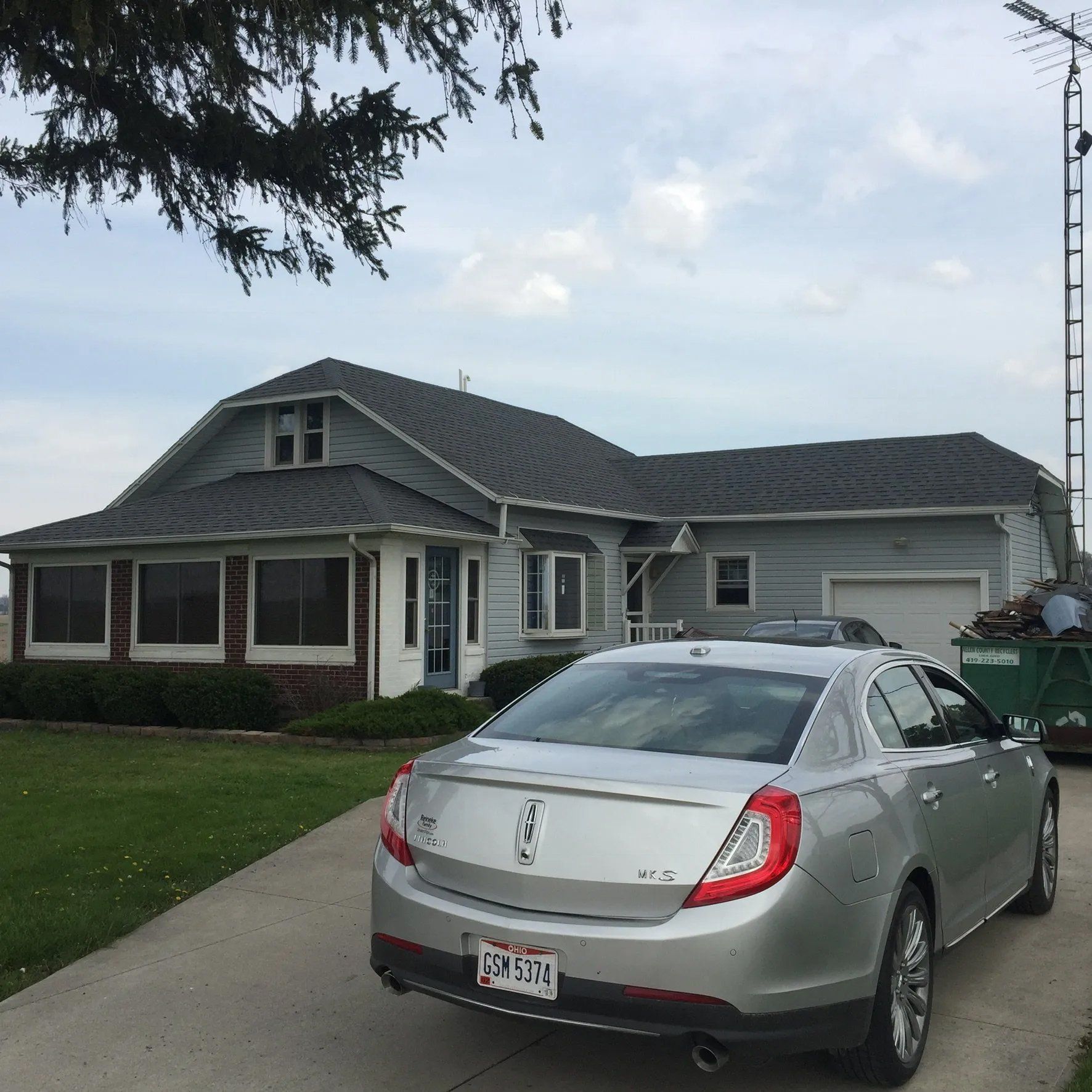 Asphalt roofing with car parked outside